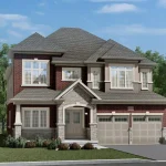 Large 44-foot detached family home at Scenic Ridge in Paris, featuring a red brick exterior, stone arched entryway, and a spacious two-car garage.