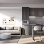 A bright, open-concept condo interior at Arte Residences, showing a modern kitchen with dark wood cabinetry, an island with bar stools, and a minimalist living room.
