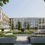 Landscaped outdoor courtyard at The Wilmot Condos featuring manicured gardens, walking paths, a shaded pergola with seating, and the building's signature gold-trimmed architecture.