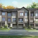 Street-level view of The Brownstone Collection in Esprit Newmarket showcasing elegant townhouses with peaked gables, grey stone facades, and landscaped front yards.