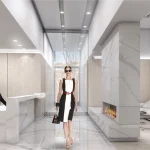 Luxury condo lobby at Nautique Lakefront Residences featuring polished marble floors, a minimalist concierge desk, a modern fireplace, and wood-paneled walls.