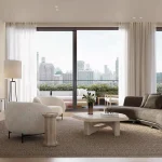Spacious open-concept living room at The Bedford with floor-to-ceiling glass sliding doors, a curved designer sofa, minimalist decor, and a large terrace overlooking the city.