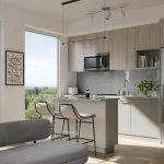 Modern open-concept kitchen and living area interior at Northshore, showcasing a kitchen island with seating, minimalist cabinetry, stainless steel appliances, and large floor-to-ceiling windows with scenic nature views.