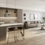 Open concept interior of a suite at The Kith Condominiums featuring a modern kitchen island and bright living room.