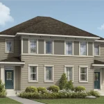 Exterior view of a two-story semi-detached home block in Cityscape featuring beige siding, dark trim, and covered front porch entries.