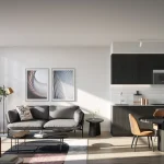 Modern open-concept suite interior at Q Tower featuring dark kitchen cabinetry, a minimalist living area with a grey sofa, and floor-to-ceiling windows with a city view.