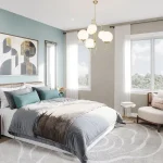 Modern primary bedroom interior at Arbor West Brampton featuring a sage green accent wall, contemporary gold chandelier, large windows with natural light, and stylish neutral decor.