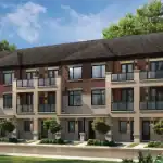 Exterior rendering of modern urban townhomes at The Enclave at Sharon Village, featuring a mix of red brick and light stone facades, glass-railed balconies, and professional landscaping under a blue sky.