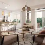 Open-concept living and kitchen area at Alister at Solterra with boho-chic decor, wicker bar stools, a white quartz island, and large sliding glass doors leading to a private balcony.