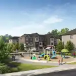 Community amenity park at The Nine development, featuring a modern children's playground with slides, sandpit, and seating areas surrounded by new townhomes.