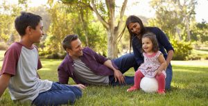 Young mixed race family relaxing with soccer ball in a park - 93fe8a6c 4c6e 141d 2c4d e5a8a392a224 scaled e1711474565616 300x153
