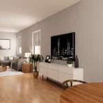 Spacious living room interior at Creekside Trail featuring a grey sectional sofa, light wood flooring, a white media console with a large city skyline art piece, and natural light from large windows.