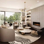 Contemporary luxury living room interior design at The Winston Collection highlighting a linear fireplace with a textured accent wall, curved designer furniture, and large glass doors opening to a balcony view.
