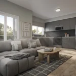 Interior rendering of an open-concept living room and kitchen at The Block on Clair, showcasing a grey sectional sofa, light wood flooring, and a modern kitchen with dark grey cabinetry and stainless steel appliances.