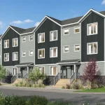 Exterior rendering of a multi-story building at The Grove Townhomes at Wildflower, featuring modern dark grey and light grey siding, stone accents, and landscaped front entryways under a blue sky.