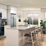 Modern open-concept kitchen and living area inside a residence at The Grove Townhomes at Wildflower, featuring white cabinetry, stainless steel appliances, a large island with seating, and a built-in home office desk.