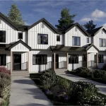 Modern white farmhouse-style townhomes with black trim and gabled roofs in the Cy Becker neighborhood, featuring concrete walkways and landscaped front yards.
