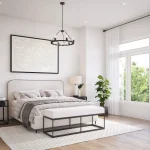 Spacious, sun-lit primary bedroom at Townhomes of Little Rouge with neutral decor, a large upholstered headboard, a black wheel-style chandelier, and wide-plank hardwood flooring.
