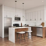 Modern open-concept kitchen at Townhomes of Little Rouge featuring a marble-patterned waterfall island, white upper cabinetry, wood-toned lower cabinets, and stainless steel appliances. of Little Rouge – Kitchen
