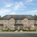 Exterior rendering of a row of brick townhouses in the Winding Woods community in Seaton, showcasing classic brick architecture with arched window details, multiple gables, covered front porches, and neat landscaping along a paved street.