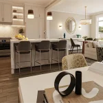 Interior view of a modern open-concept kitchen and living area in an Erin Glen townhouse, featuring a white marble island with seating, pendant lighting, and light hardwood floors.