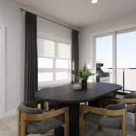 Contemporary dining area at Poppy at Rangeview Auburn model showing a black oval dining table with gold-framed chairs next to a sliding glass door leading to a private balcony.