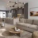 Open concept interior of a West Brooklin home showing a modern kitchen with a large island, stainless steel appliances, and a bright living room area.