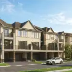 Exterior rendering of the Chateau 9 Townhome Collection in Stouffville, featuring modern three-story architecture with stone and stucco facades, spacious balconies, and integrated garages under a clear blue sky.