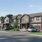 Streetscape view of modern grey-brown townhomes at Wellwood with attached garages, parked cars, and paved driveways.
