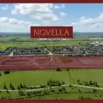 Aerial view of the Novella Estates construction site in Meadowvale, showing land clearing and infrastructure development for a new residential community adjacent to green space.