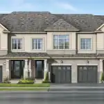Architectural rendering of a modern townhome block at On The Ridge, featuring a mix of stone and stucco exteriors, dark garage doors, and elegant gabled rooflines under a clear blue sky.