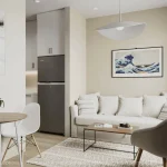 Bright, contemporary living room interior at Warbler Place Welland with a neutral color palette, cozy white sofa, minimalist decor, and a view into the kitchen.