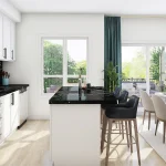 Luxury kitchen design at Sol Stacked Towns showcasing white cabinetry, black marble countertops, a central kitchen island with seating, and a bright dining area leading to an outdoor terrace.