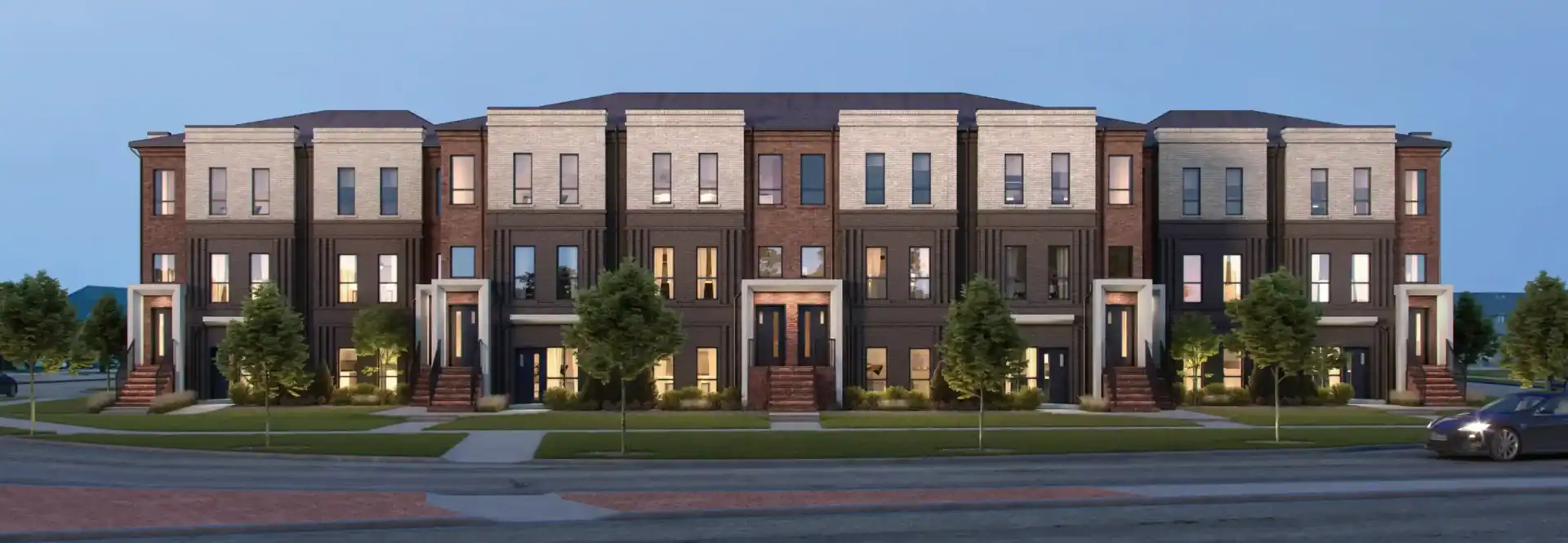 Architectural rendering of Sol Stacked Towns exterior featuring modern multi-level brick and stone facades with landscaped front yards and clean architectural lines under a clear twilight sky.