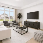 Bright and airy living room interior at West Community showing a neutral white sofa, dark wood media console, large windows with natural light, and contemporary minimalist decor.