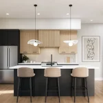 Modern open-concept kitchen interior at Black Birch Heights Condos, showcasing a dark gray island with three beige barstools, light wood cabinetry, and sleek stainless steel appliances.
