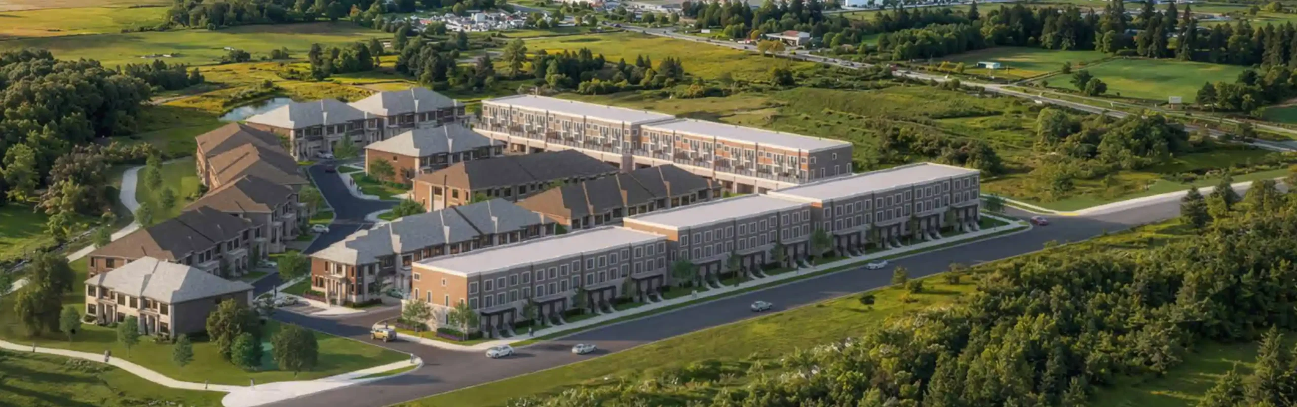 Aerial rendering of the Kingshaven residential townhouse community surrounded by lush green fields and trees.