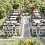 High-angle aerial rendering of the OG Urban Towns multi-family development project, showcasing modern multi-story townhomes with rooftop terraces surrounded by lush green and autumn-colored trees.