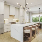 Modern open-concept kitchen interior at The Elms of Thornhill Woods, showcasing a marble-veined waterfall island with wooden barstools, minimalist white cabinetry, gold fixtures, and an adjacent bright dining area.