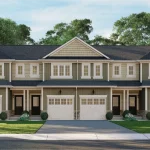 Front elevation view of light green and cream two-storey townhomes at Everford Towns featuring white garage doors and landscaped lawns.