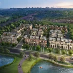 High-angle aerial rendering of the Jefferson Heights townhouse community development, showcasing modern multi-level units surrounded by lush green spaces, a paved roadway, a lakeside walking trail, and a distant city skyline under a twilight sky.