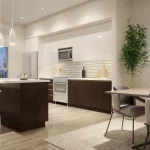 Modern open-concept kitchen and dining area with dark wood cabinets, white upper cupboards, and a large island at Blue Vista.