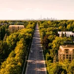 Aerial view of a lush green tree-lined boulevard featuring labels for The Bridle Estate and The Bridle Prestige, leading toward the Toronto city skyline in the background.