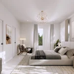 Bright luxury master bedroom interior at Bayview Heights with a upholstered bed, large gold round mirror, contemporary chandelier, neutral tones, and expansive windows.