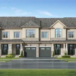 Architectural rendering of traditional townhomes at Dreamfields in Bradford, featuring a light stone and stucco facade, built-in single garages, and front porch entryways.
