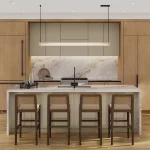 Contemporary open-concept kitchen at Everpine featuring light wood cabinetry, marble waterfall island, dark wood barstools, and modern pendant lighting.