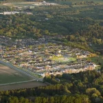 Aerial view of the Everstone by Cachet residential development surrounded by lush green forests, farmland, and countryside in Elora.