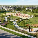 High-angle view of the central community park at Everstone by Cachet, featuring walking paths, a children's playground, open green space, and a wooden shade trellis.