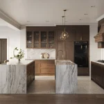 Modern luxury kitchen in a Five Oaks single-family home with double marble waterfalls, dark wood cabinetry, integrated double ovens, and brass hardware.