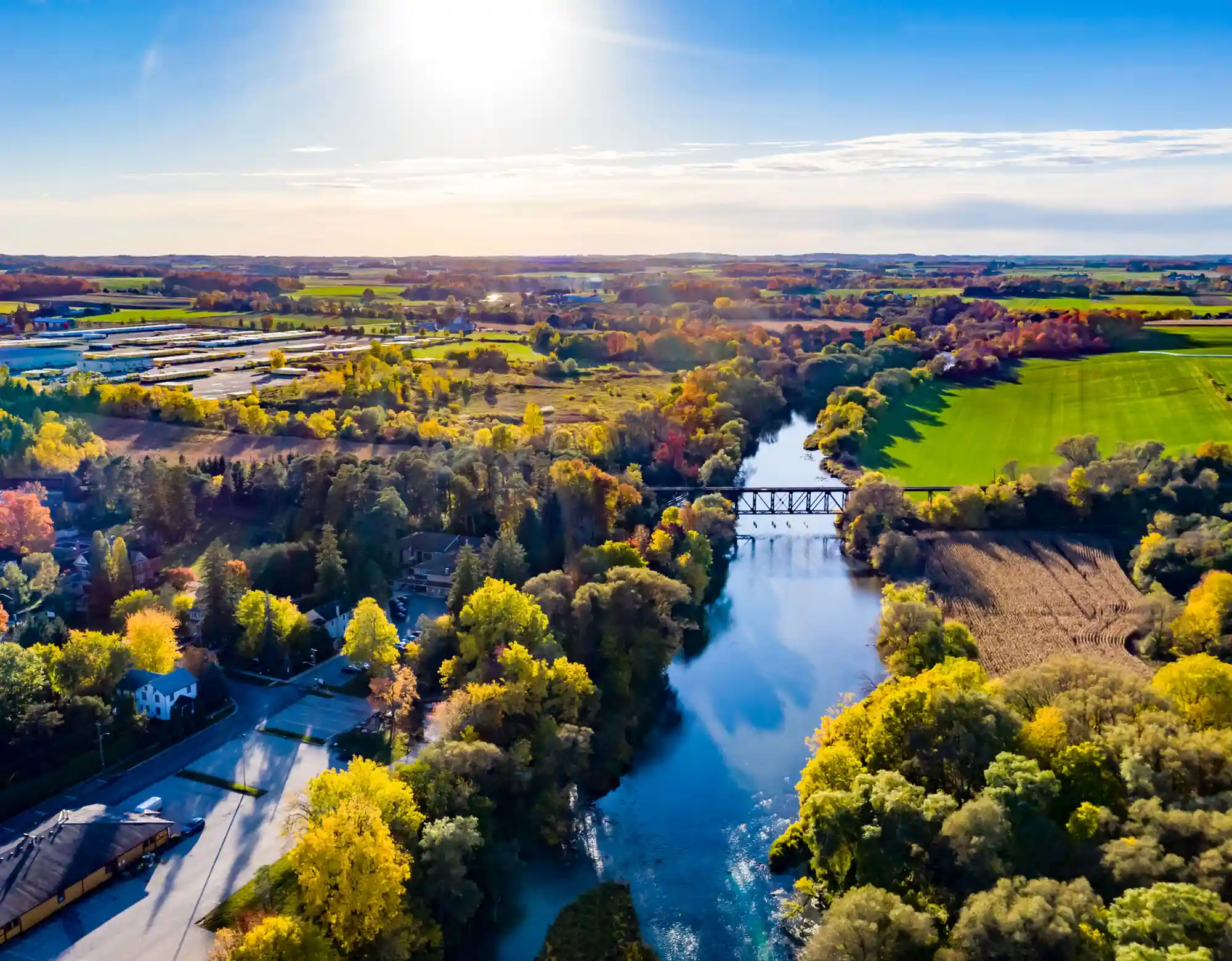 Aerial view of Laurel Creek flowing through lush autumn foliage and green landscapes near Waterloo